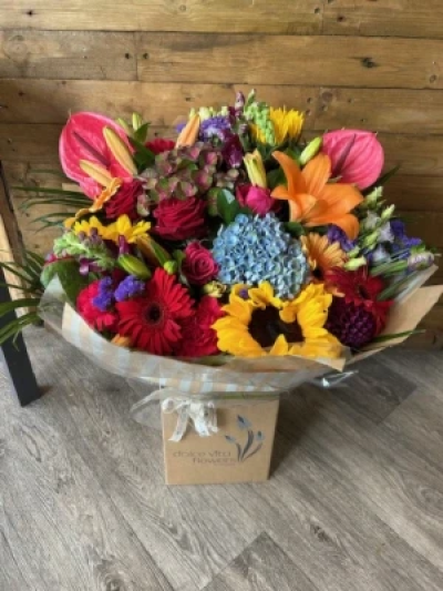 Dream Bouquet - This dream bouquet comes with a variety of flowers including roses, lilies, anthuriums, blooms, gerberas, lisianthus, statice, carnations and a wonderful mix of greenery. Flowers may vary according to season and availability. We will include a handmade paper flower keepsake while stocks last. This bouquet comes in a large presentation box with food and water for longer lasting stems.