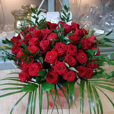50 Red Roses - Let us create the WOW factor for you with 50 beautiful red roses in an aqua pack with romantic wrapping and diamantes throughout.