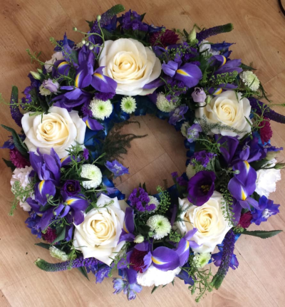 Purple & White Wreath - A beautiful purple and white wreath.tribute. Exact flowers used may vary slightly depending on availability.