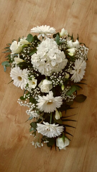 White Tribute - White classic tribute using white gerberas, gypsophila and roses along with other flowers to compliment.