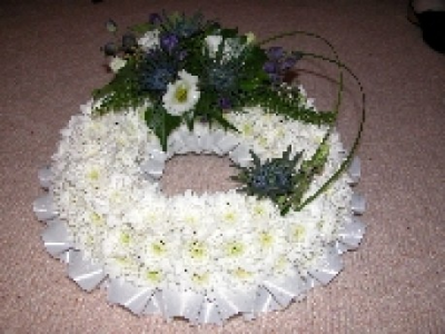 Tribute 13 - Traditional Based Wreath with white base and traditional spray. You may choose different colours for spray if you like. Sizes 12", 14", 16" size shown 16".